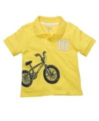 Whether he gets around by bike, truck or animal, he'll do it while looking great in a sporty graphic polo shirt from Osh Kosh.