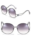 Elegant metal oversized sunglasses with round frames and curving wire arms.