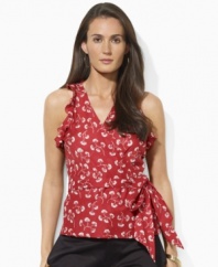Lauren by Ralph Lauren's flirty wrap silhouette exudes undeniable femininity in a sleeveless blouse, accented with a vibrant print and ruffled sleeves for a charming summer look.
