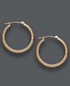 A stylish complement to any ensemble. These medium-sized hoops feature a 14k rose gold setting with a unique diamond-cut design. Approximate diameter: 1-1/8 inches.