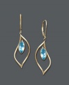 Cool blues. Earrings feature bezel-set blue topaz drops (2-1/2 ct. t.w.) crafted in a dainty 14k gold hoop setting. Approximate drop: 1-1/2 inches.