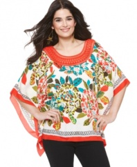 A vibrant burst of color and a flowing cut make ECI's poncho your new go-to top!