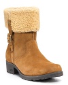 Fashionable cold weather suede boots with a genuine shearling cuff and side belt detail from UGG® Australia.