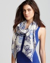 Gorgeous patterns of birds of paradise embellish a oblong wool scarf from Inoui.