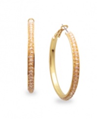Party-perfect hoops. Add a flash of rich color to your look in c.A.K.e. by Ali Khan's sparkling champagne hoop earrings. Crafted in gold tone mixed metal with glass accents. Approximate diameter: 1-5/8 inches.