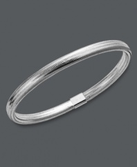 Layer it up for a fresh, new look! This unique bangle bracelet features a silver tone silicone setting with a 14k white gold joint clasp. Approximate diameter: 2-1/2 inches.