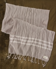 Light and airy, a woven cotton scarf with bold stripes and fringed ends adds graphic dimension to any look