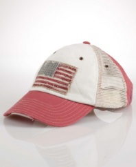 A rugged baseball cap is crafted from subtly faded and abraded cotton twill with mesh panels and an American-flag patch for authentic character.
