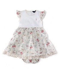 A pretty day dress is styled with a charming floral print and contrasting trim.