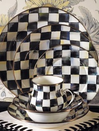 A charming way to add color and personality to the dinner table, crafted in a checkerboard juxtaposition of ivory and onyx with bronzed stainless steel trim. Enameled steel 12 diam. Dishwasher safe Made in USA 